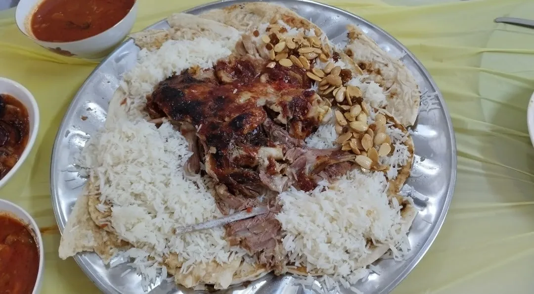 Lamb mandi with fall-off-the-bone lamb over smoky saffron rice