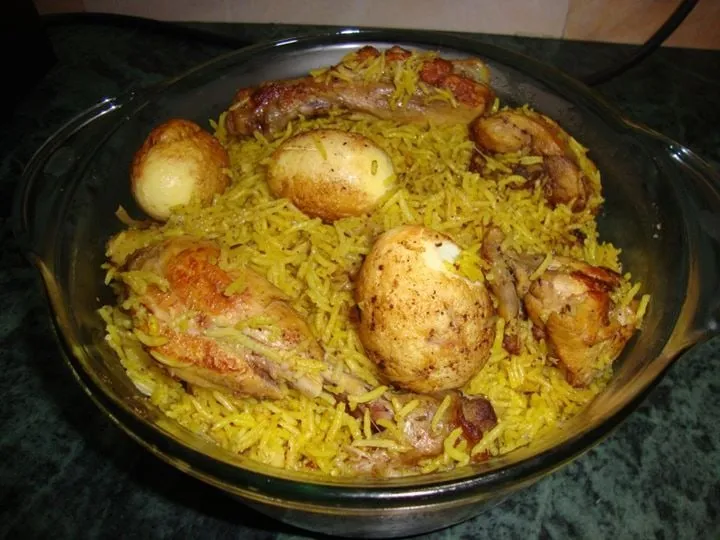 Pakistani chicken biryani served in a large dish with fried onions and coriander